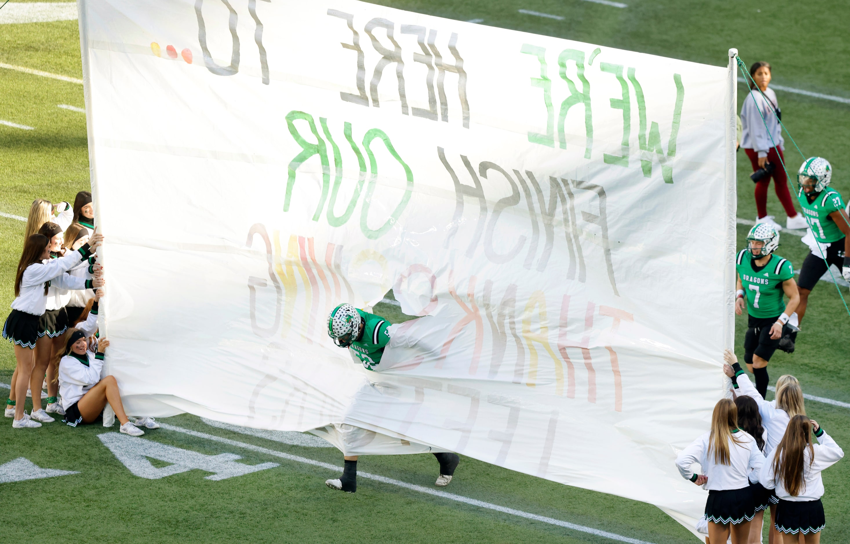 Southlake Carroll offensive lineman Tyler Scarborough (52) leads the Dragons through the...