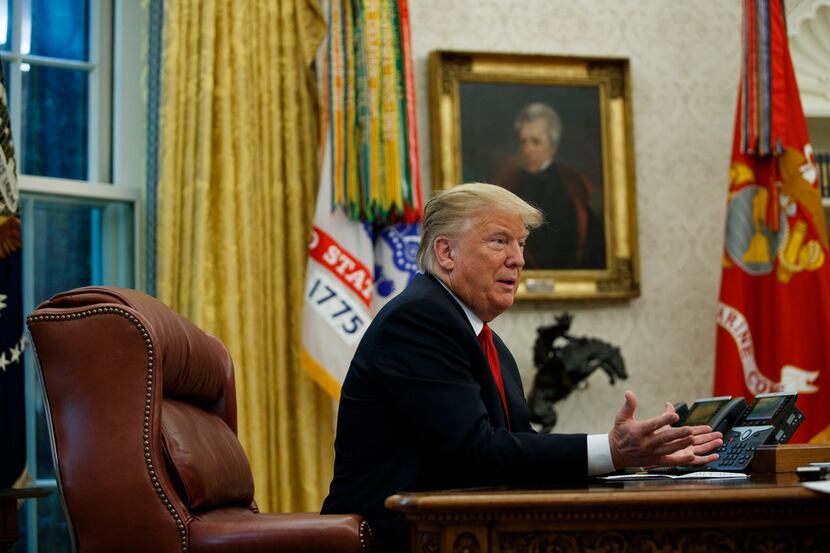 President Donald Trump speaks during an interview with The Associated Press in the Oval...