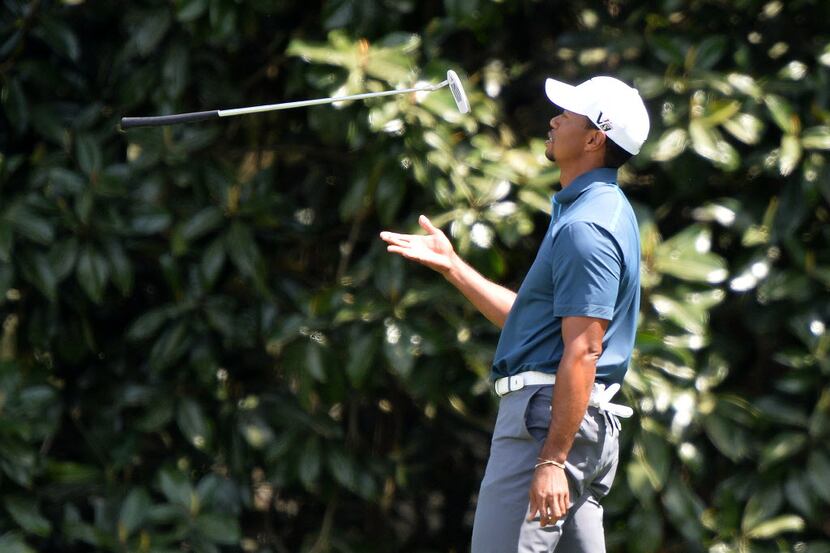 Tiger Wood of the US tosses his club during the third round of the 77th Masters golf...