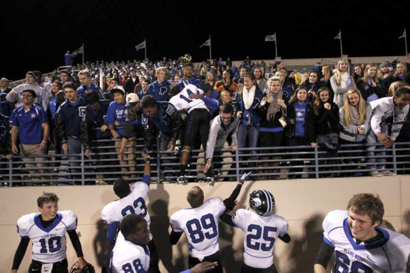 Plano West players celebrate with their fans after a playoff-clinching, 42-17 win against...