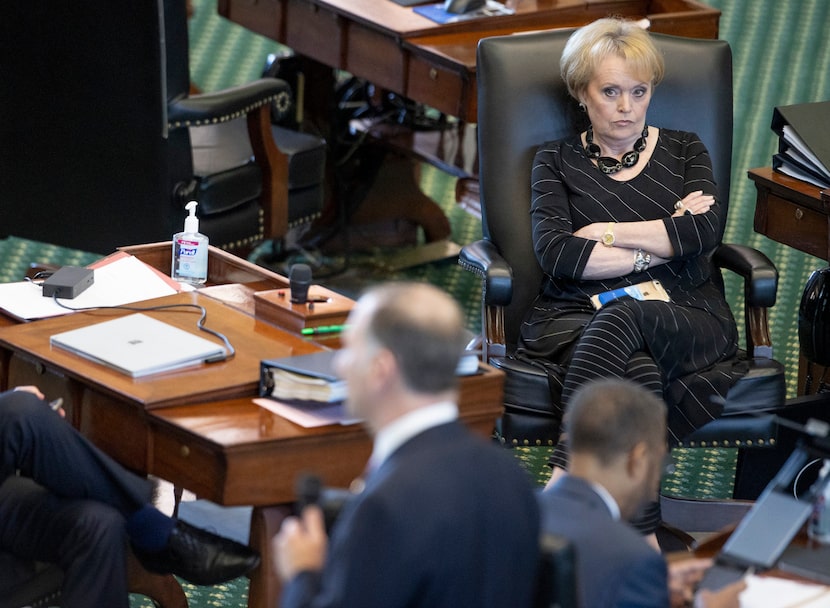 State Sen. Beverly Powell, D - Burleson, listens to State Sen. Charles Schwertner, R -...