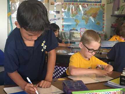 Alec Gonzalez and Corbin Kroeker are partners during a math exercise. They are enrolled in...