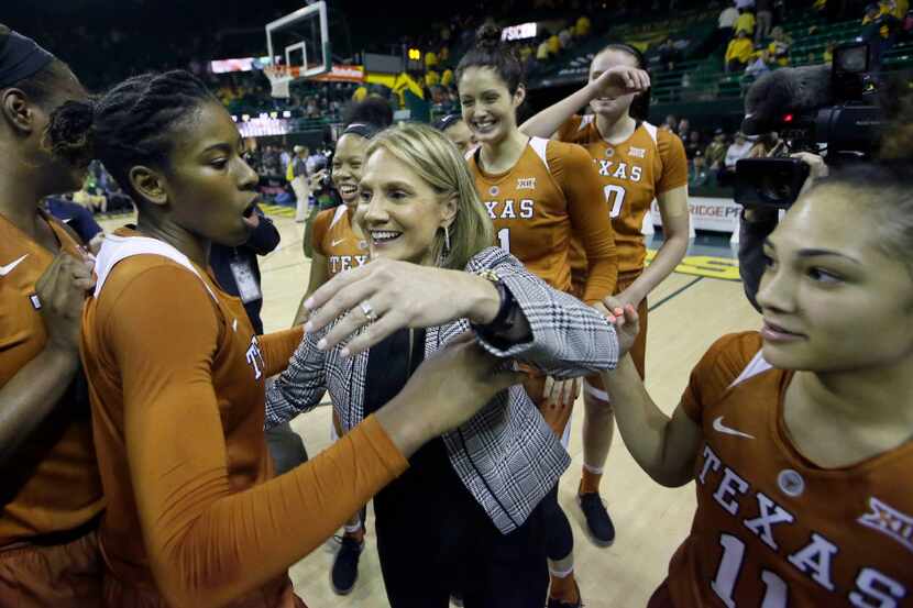 Texas head coach Karen Aston, center, celebrates with teammates Ariel Atkins, left, Brooke...