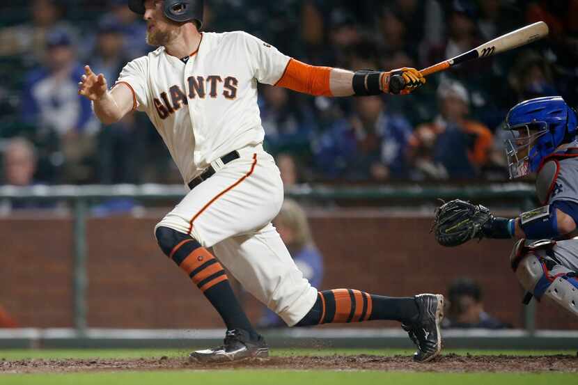 In this Tuesday, Sept. 12, 2017 file photo, San Francisco Giants' Hunter Pence hits a single...