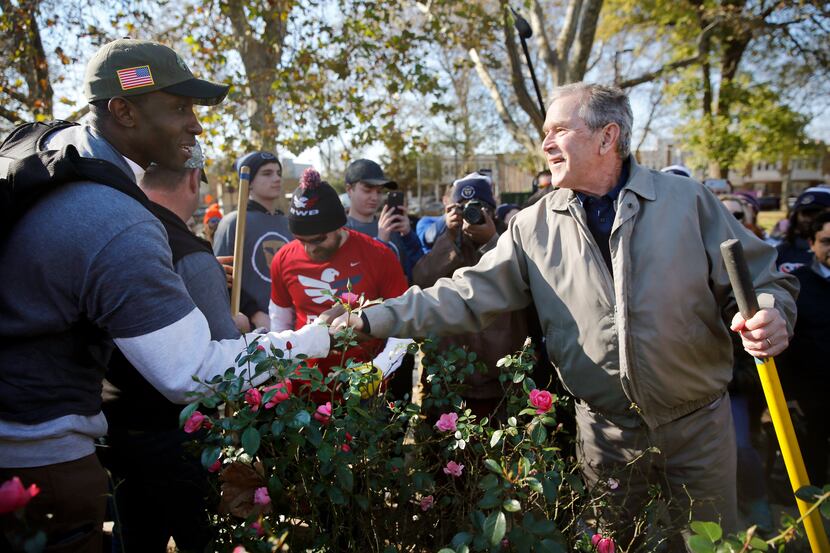 Former President George W. Bush shakes hands and thanks veteran Navy submarine officer...