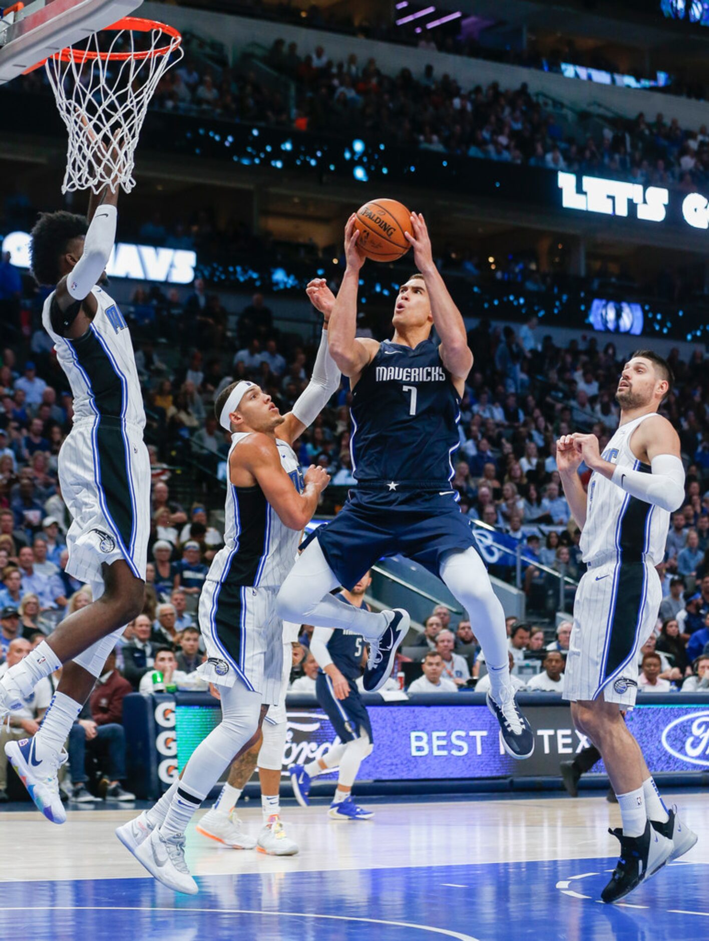 Dallas Mavericks forward Dwight Powell (7) goes up for a shot past Orlando Magic forward...