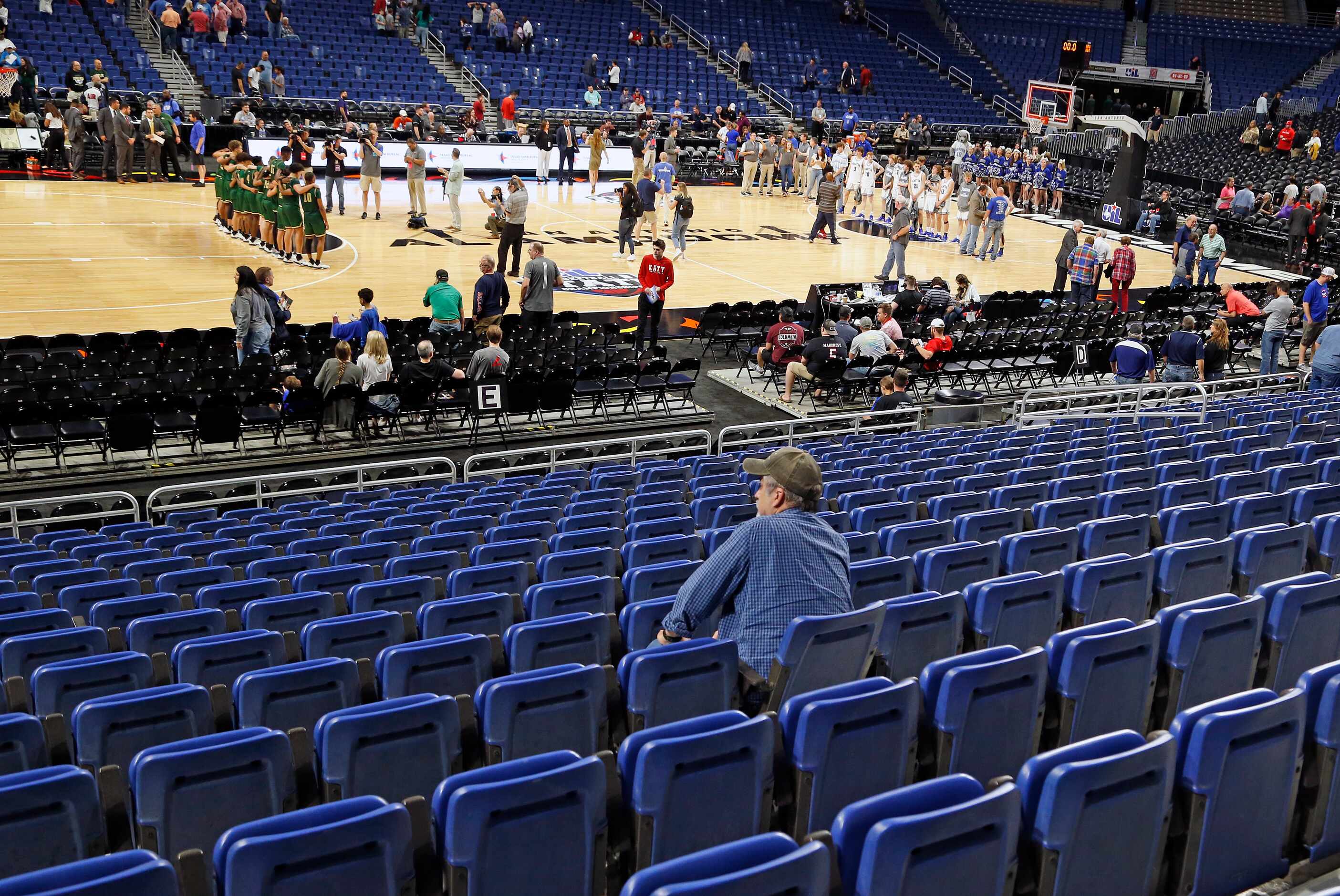 A lone fan watches the ceremony following the last game of the tournament.  San Antonio Cole...