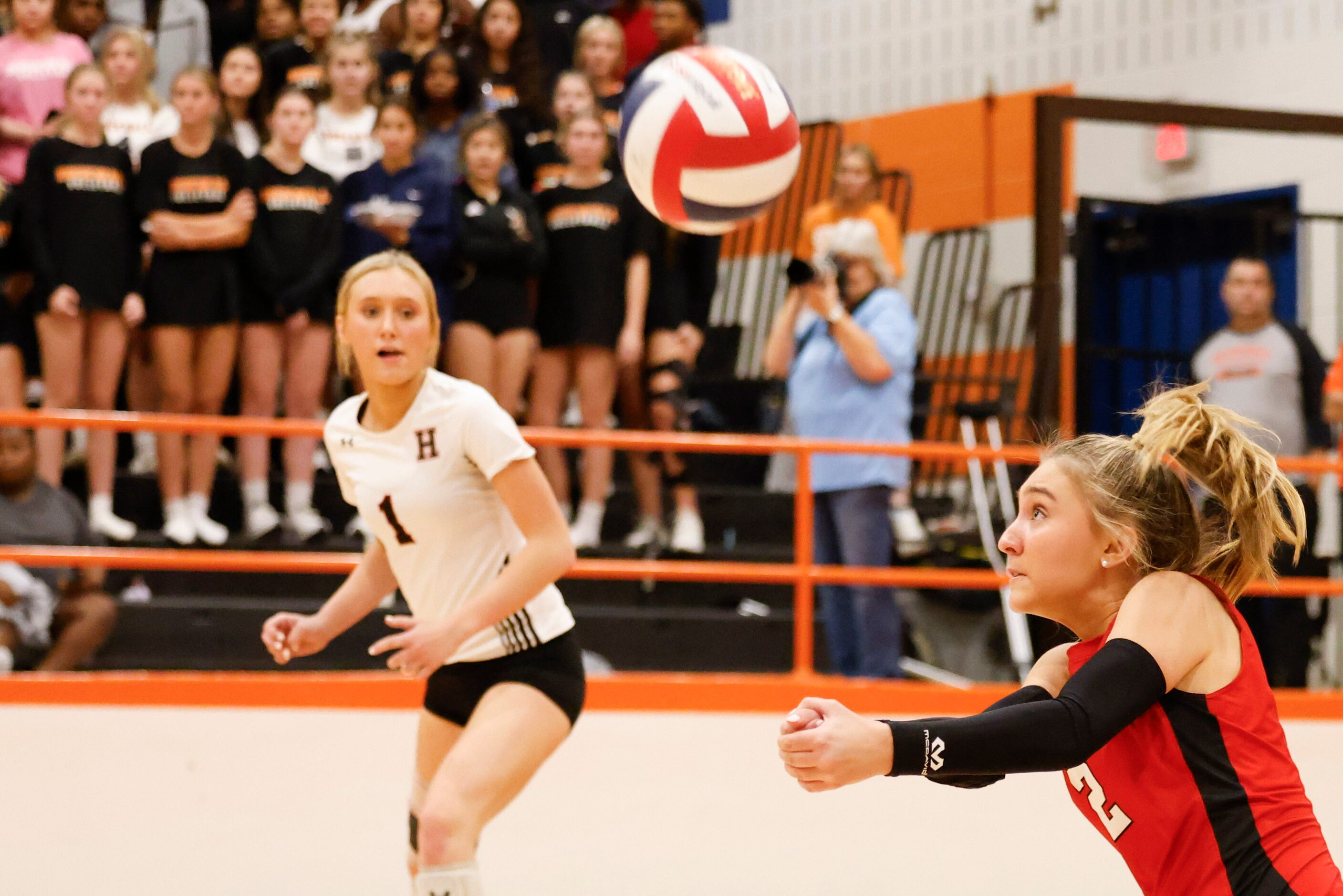 Rockwall heath’s Reese Ruecker (right) digs the ball as Reagan Ruecker watches during a...