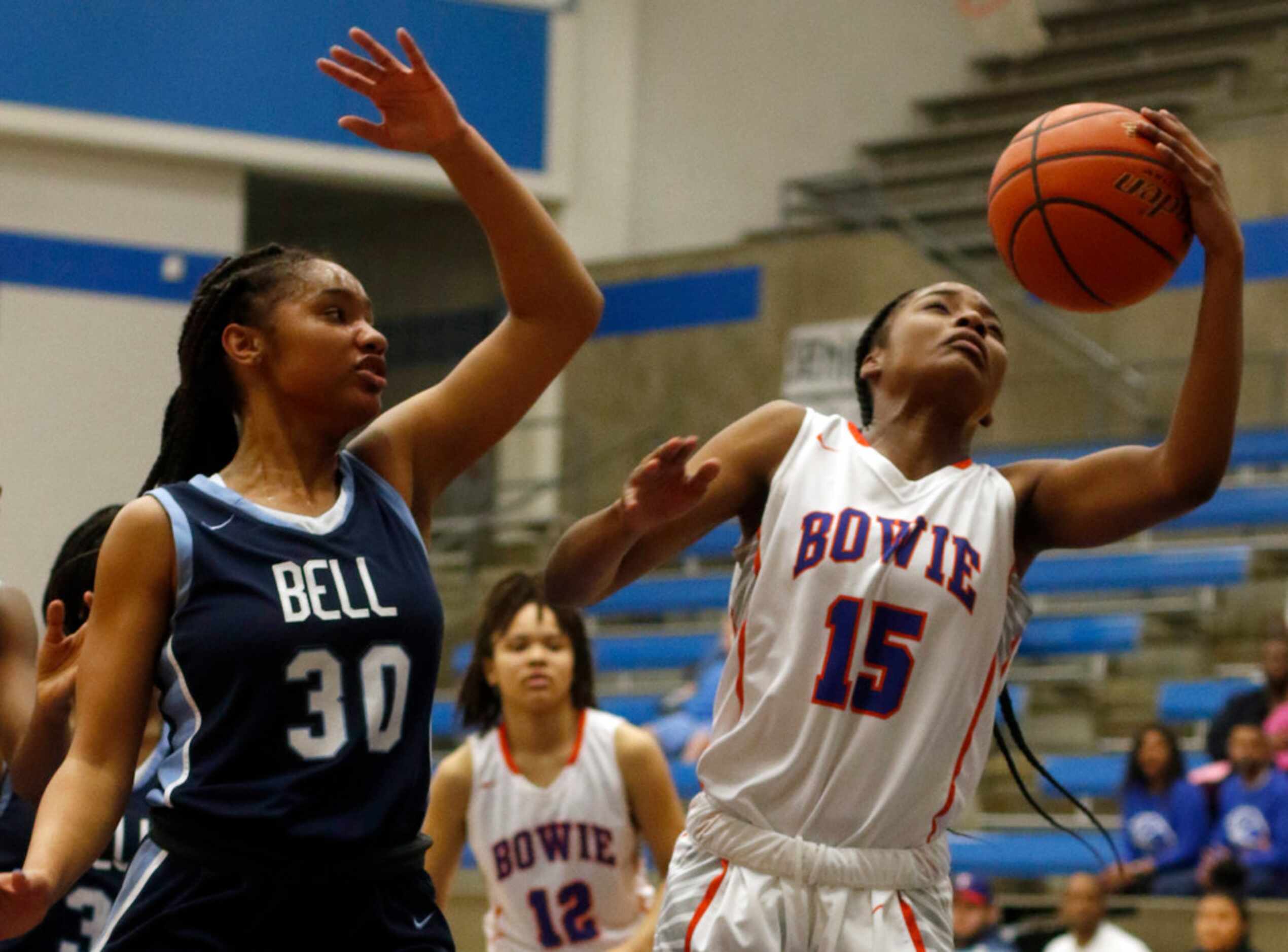 Arlington Bowie guard Alaisha Brown (15) pulls down a defensive rebound in front of Hurst...