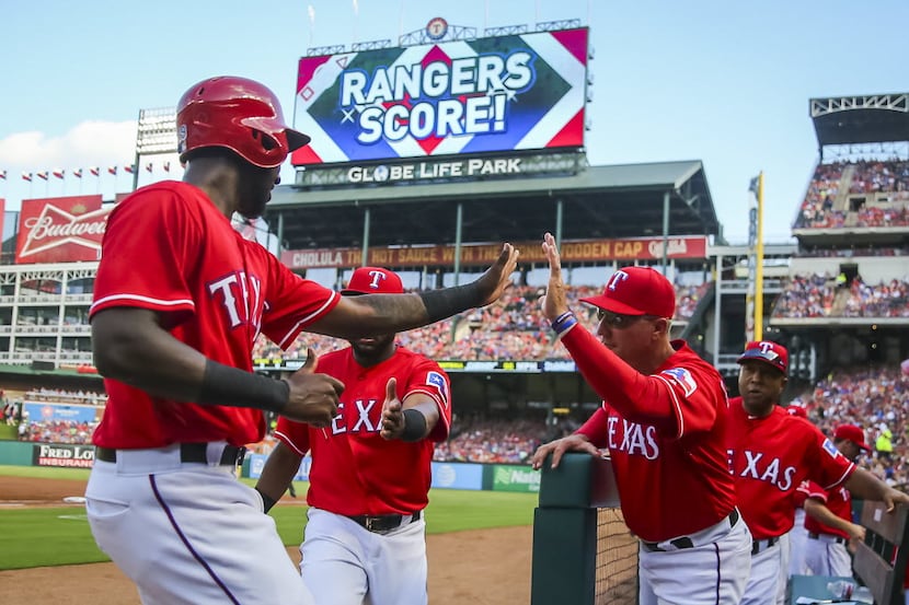 Texas Rangers second baseman Jurickson Profar celebrates with manager Jeff Banister after...