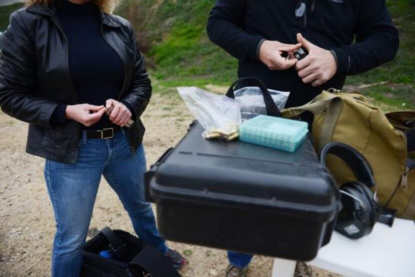 Dallas Pistol Club members Kerry Shulman and Wayne Dobbs load a round of bullets at the range.