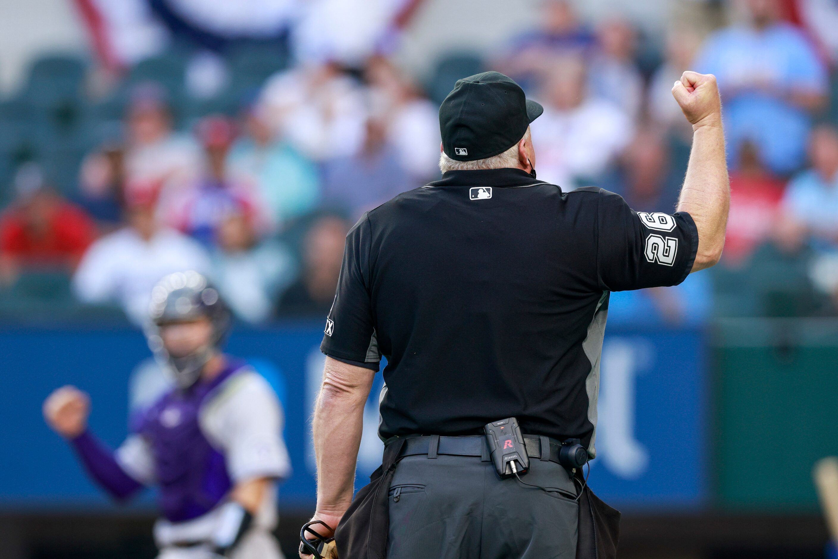 Umpire Bill Miller (26) overturns a call on the field after the Colorado Rockies challenged...