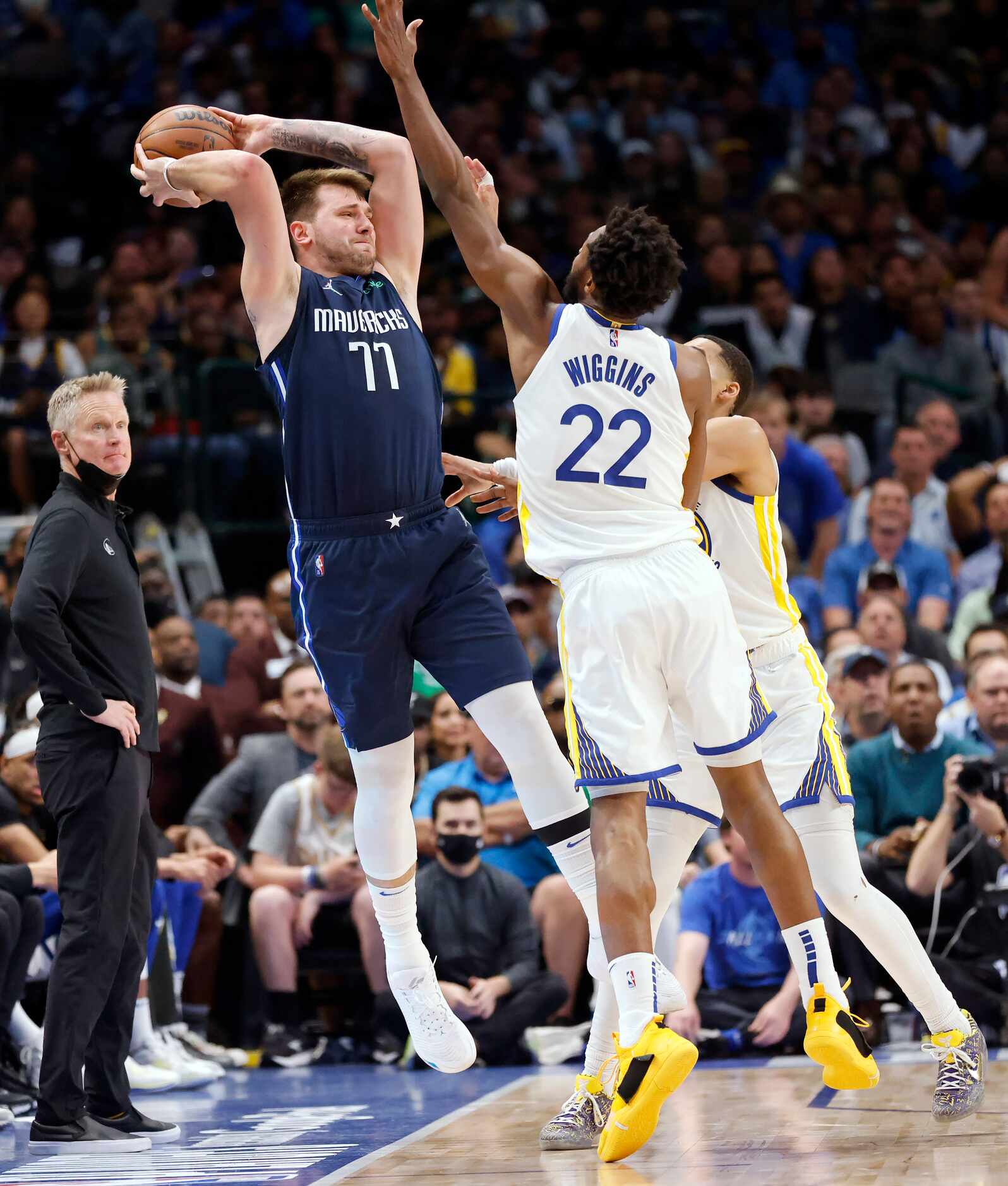 Dallas Mavericks guard Luka Doncic (77) passes the ball after he's forced out of bounds by...