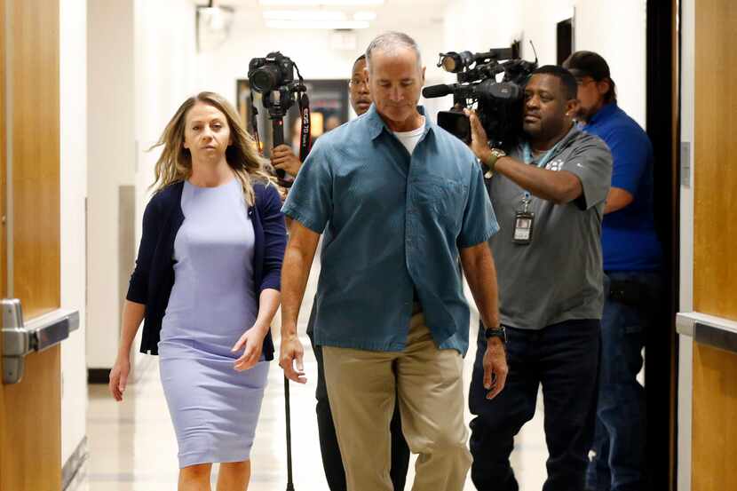 Fired Dallas police Officer Amber Guyger (left) arrives for a pretrial hearing in her murder...