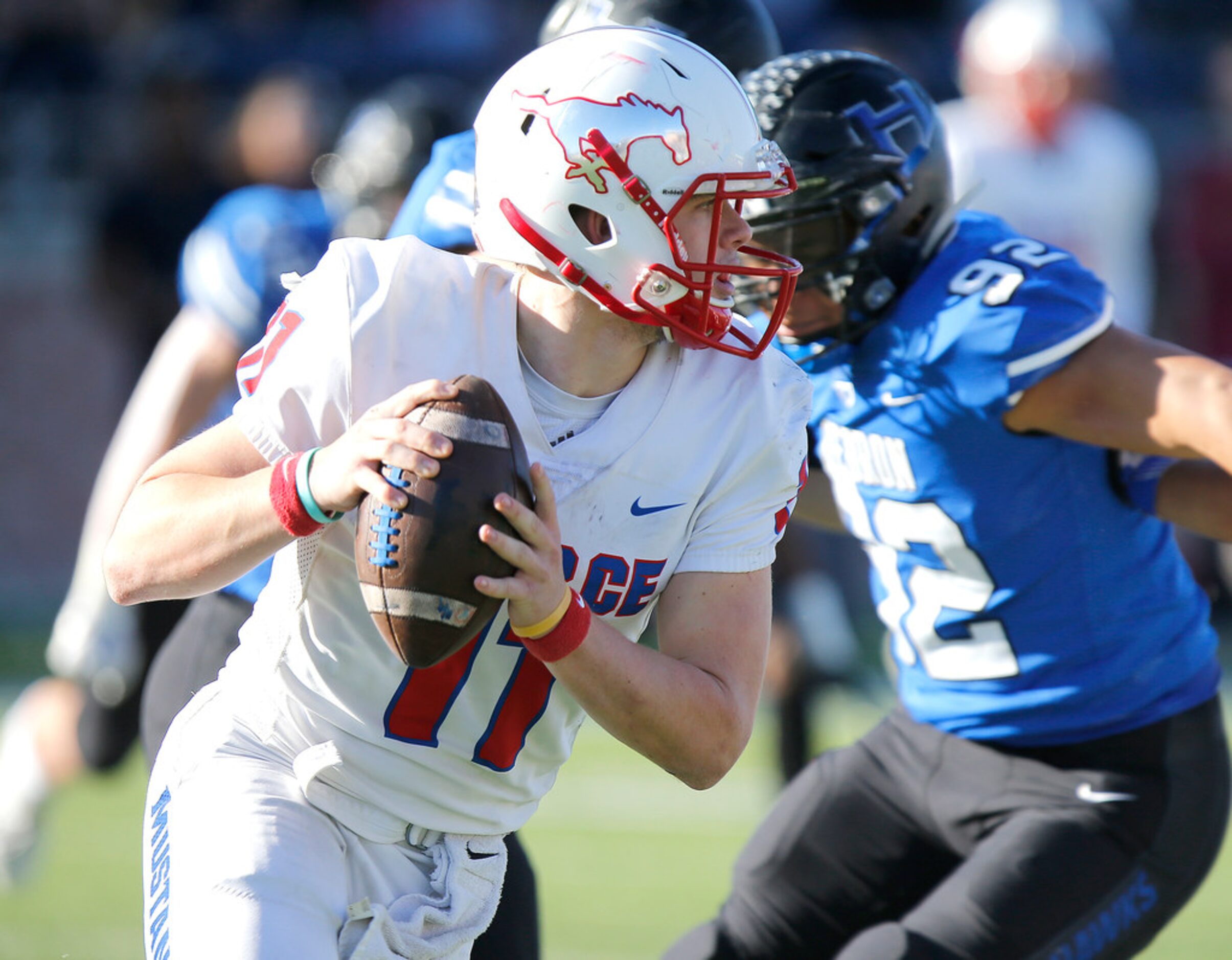 Pearce High School quarterback Bo Brewer (11) scramble during the fourth quarter as Pearce...