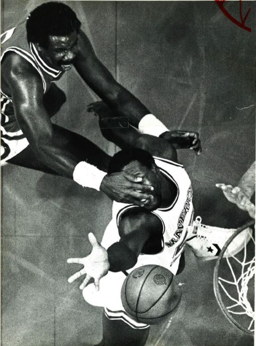 Kansas City's Reggie King gets a handful of Mavericks forward Clarence Kea's face instead of...