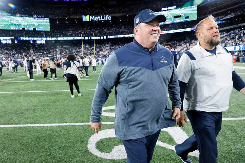 Dallas Cowboys head coach Mike McCarthy (center) walks off the MetLife Stadium field with a...