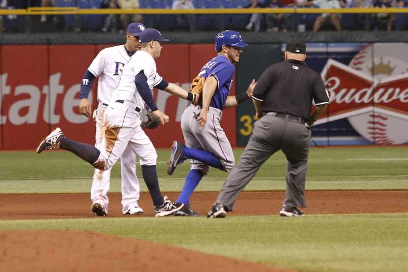 Tampa Bay Rays third baseman Evan Longoria (3) tags out Texas Rangers second baseman Ian...