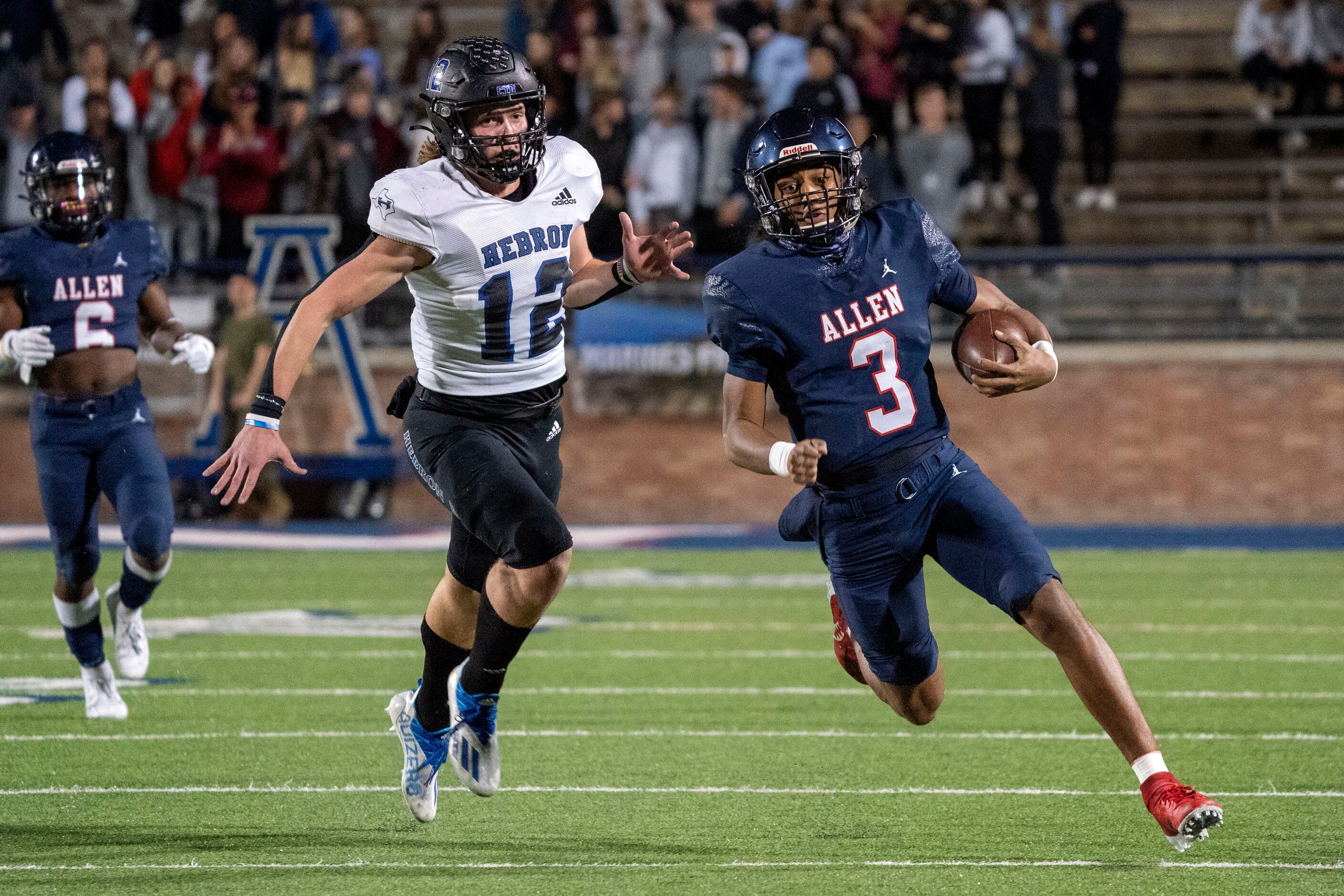 Allen sophomore quarterback Mike Hawkins (3) turns the corner past Hebron defensive lineman...