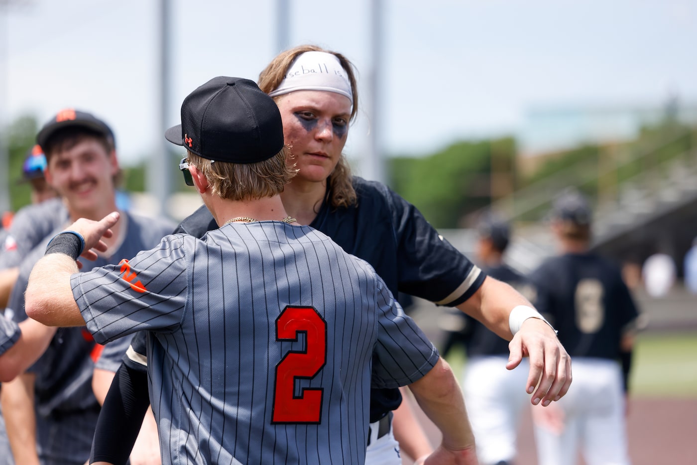 Rockwall senior infielder Brayden Randel (2) embraces Mansfield catcher Parker Burt after an...