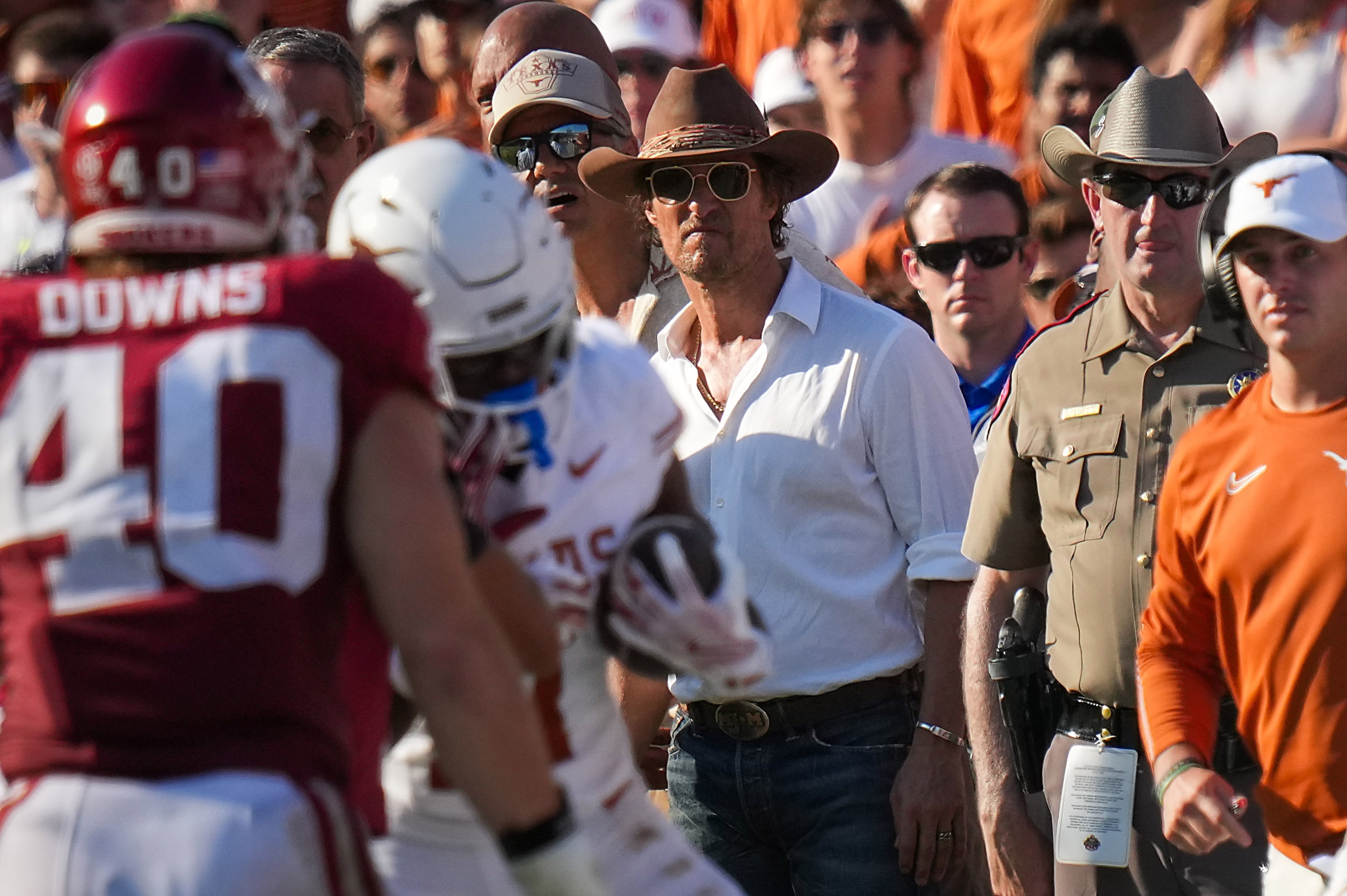 Actor Matthew McConaughey watches from the sidelines during the second half of an NCAA...