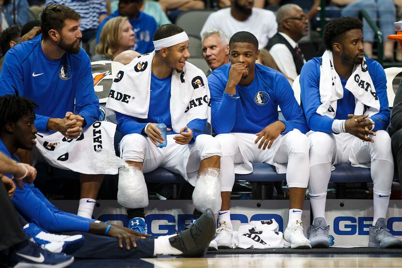 Dallas Mavericks guard Dennis Smith Jr. (second from right) laughs with guard Seth Curry...