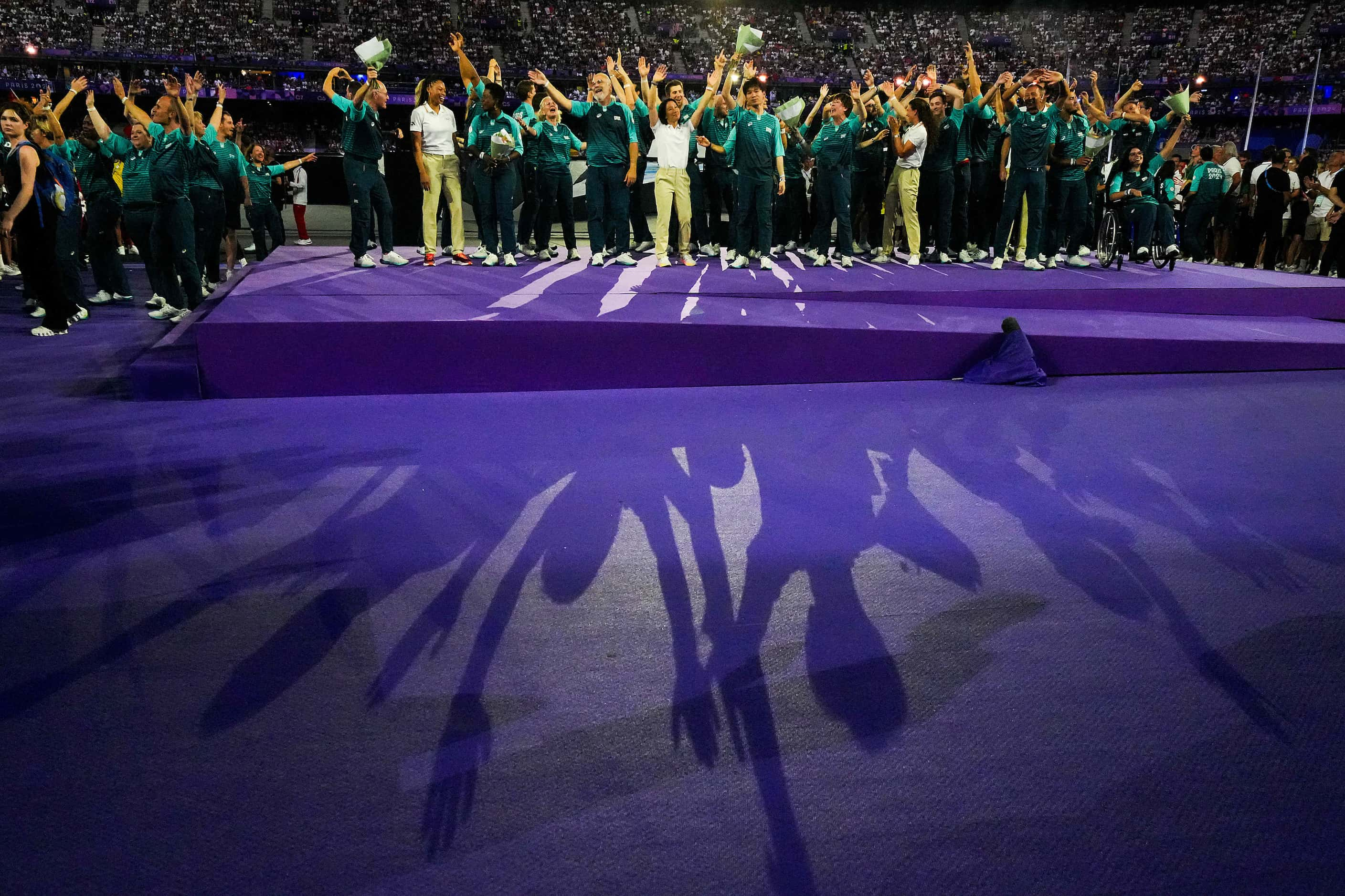 IOC Athletes' Commision newly-elected members wave alongside volunteers as they are...