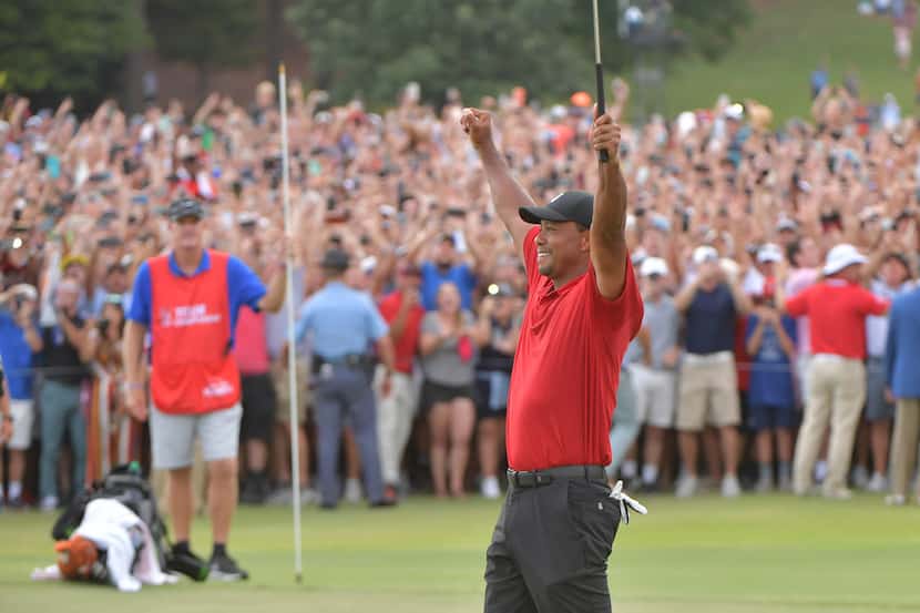 Tiger Woods celebrates as he wins the Tour Championship on the 18th green during the final...