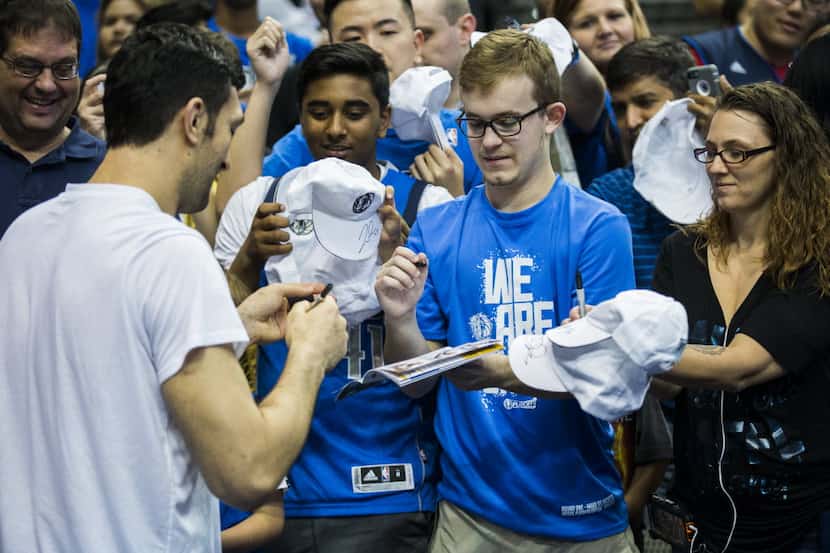 Dallas Mavericks center Zaza Pachulia (27) signs autographs for fans before game 4 of their...
