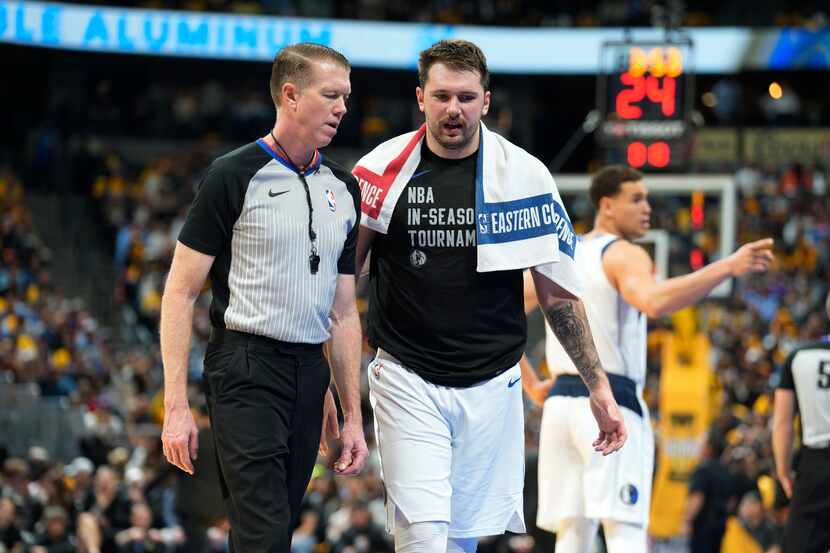 Dallas Mavericks guard Luka Doncic, right, confers with referee Ed Malloy during the second...