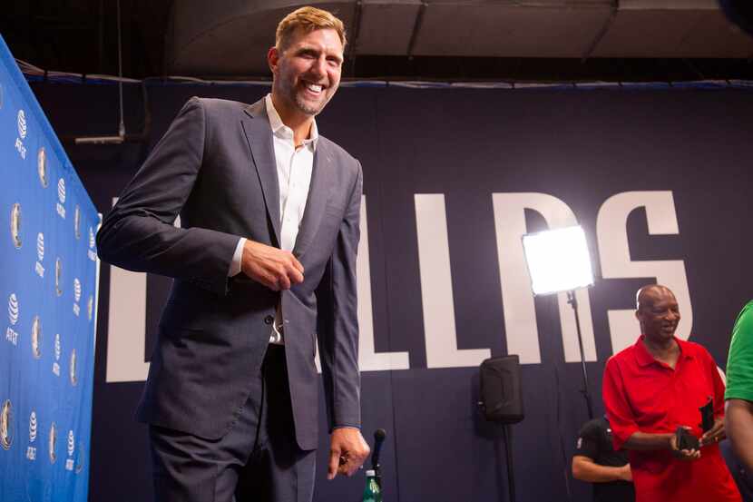 Retired Dallas Mavericks player Dirk Nowitzki walks off after speaking about his induction...