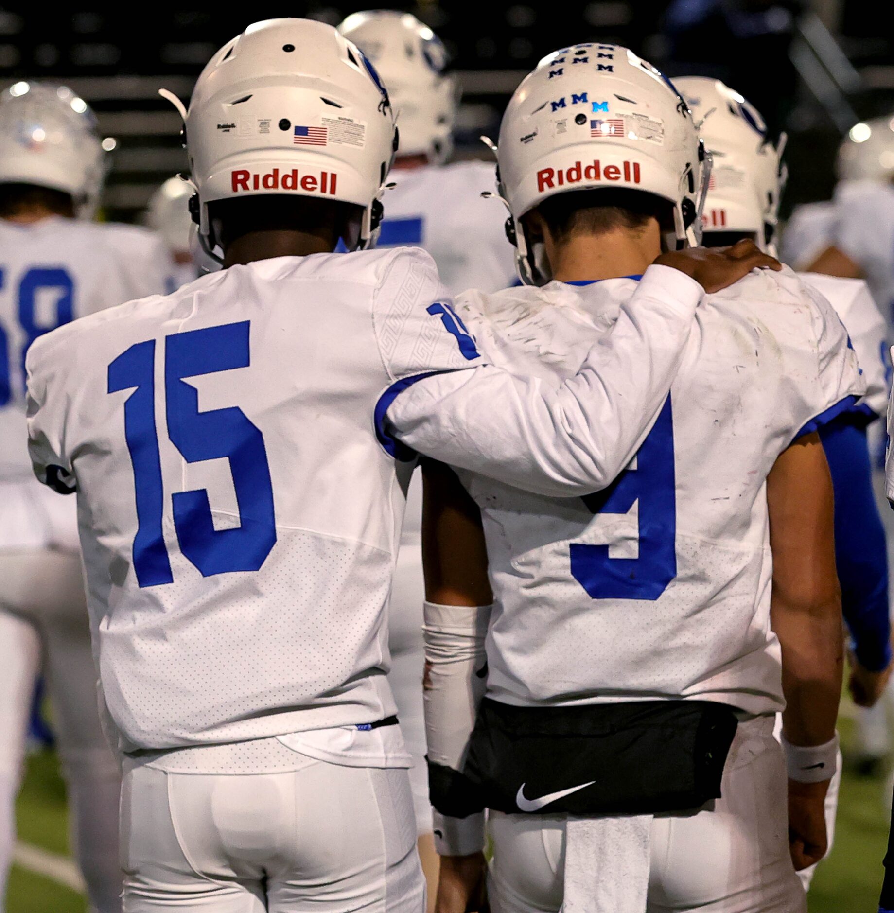 Midlothian quarterback Chad Ragle (9) and wide receiver Julius Cervera (15) walk off the...