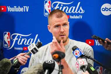 Boston Celtics center Kristaps Porzingis talks with reporters before basketball practice,...
