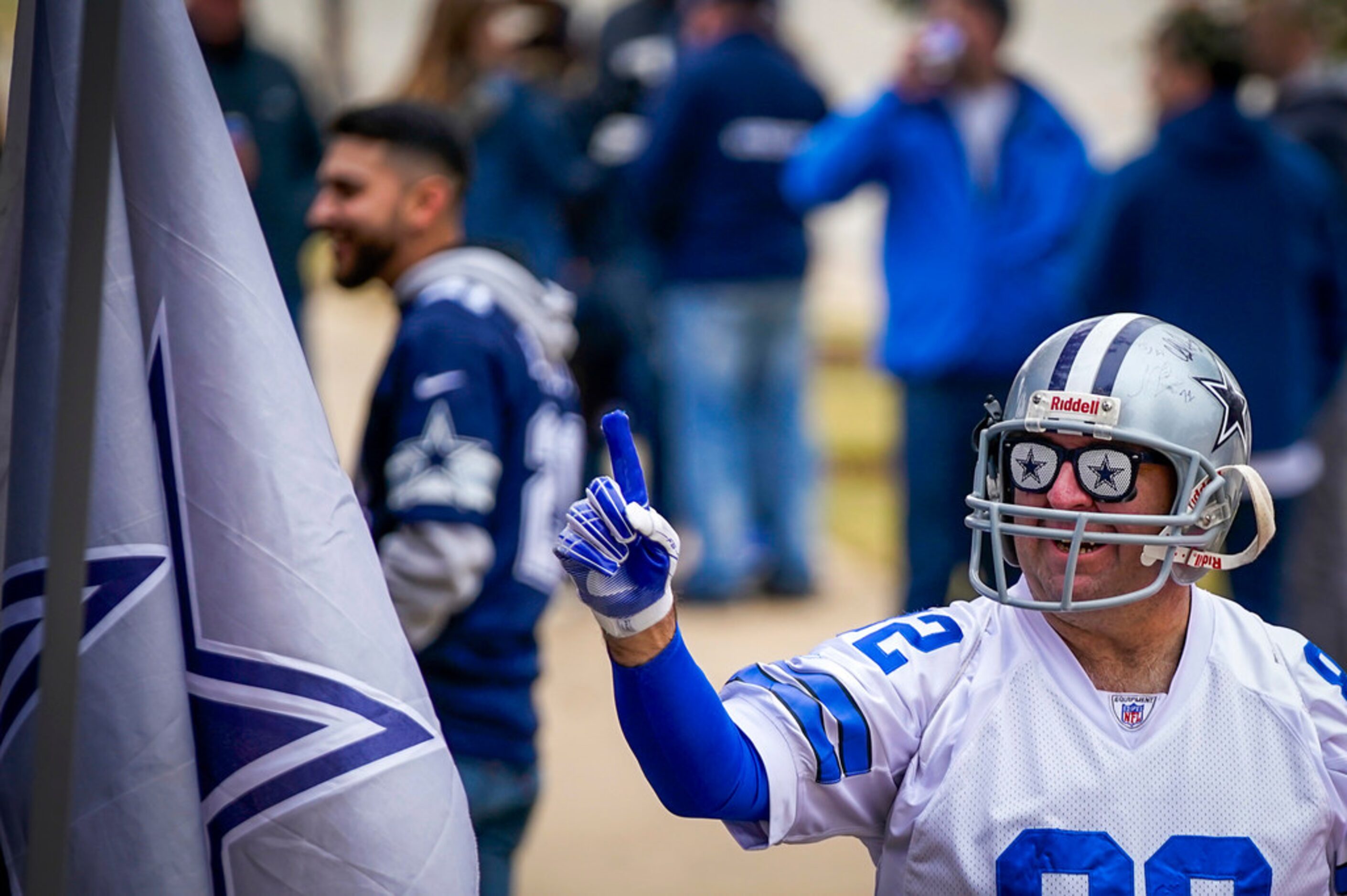 Dallas Cowboys Mark Wilhite of Amarillo heads to the stadium as fans tailgate before an NFL...