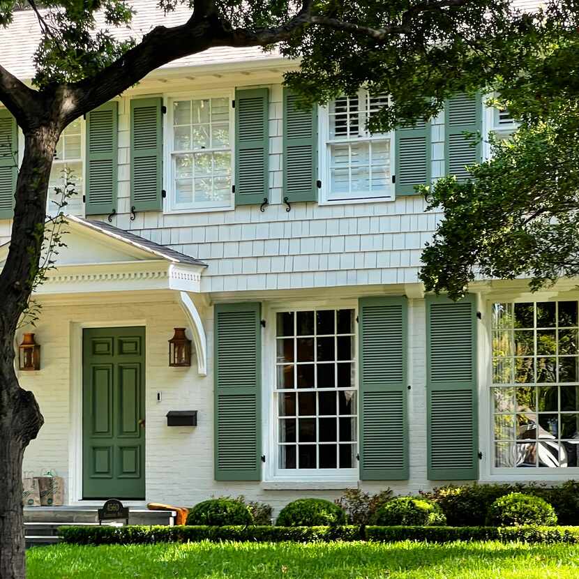 Home exterior, painted white with green shutters and front door