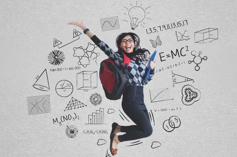 Portrait of female student with glasses jumping with school doodles in the background.