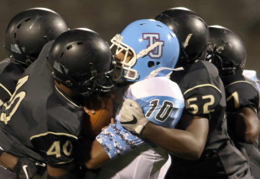 Dallas Thomas Jefferson quarterback Ty Thomas (10) feels the crunch of the Dallas South Oak...