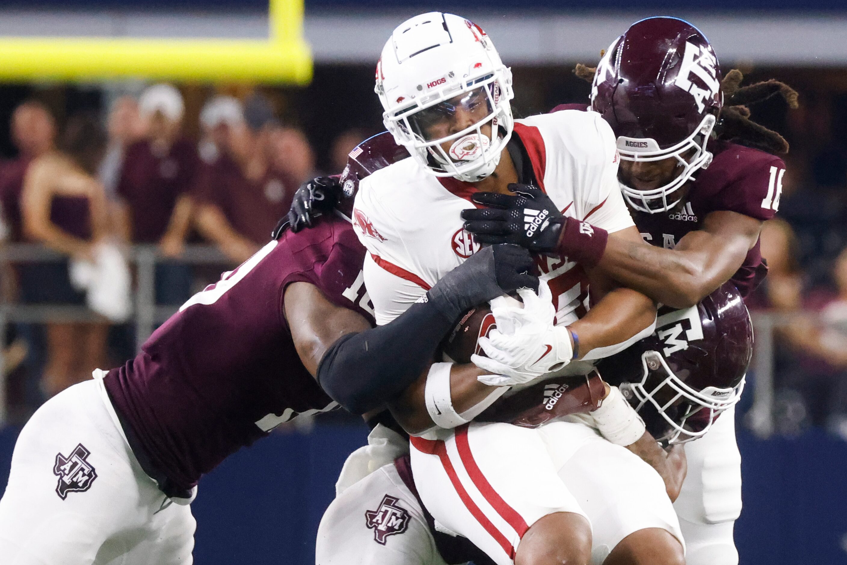 Arkansas running back Dominique Johnson (20) gets tackled by Texas A&M tight end Donovan...