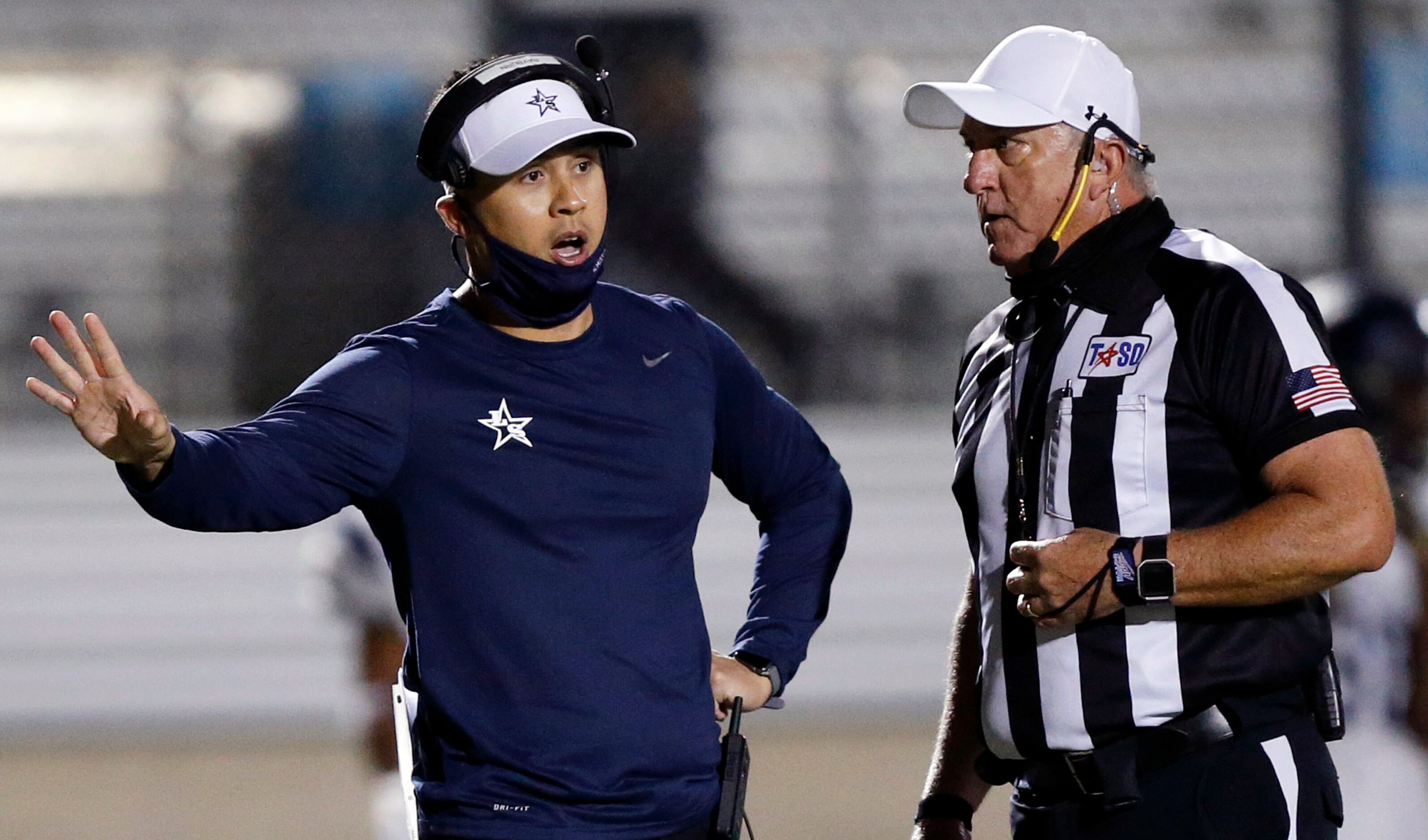 Frisco Lone Star head coach Jeff Rayburn visits with an official late in the game against...