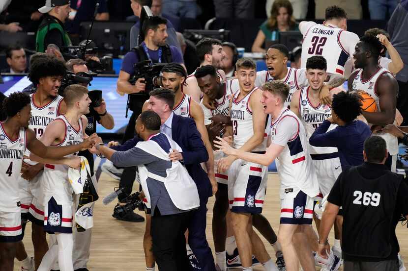 Connecticut players celebrate their win over San Diego State in the men's national...