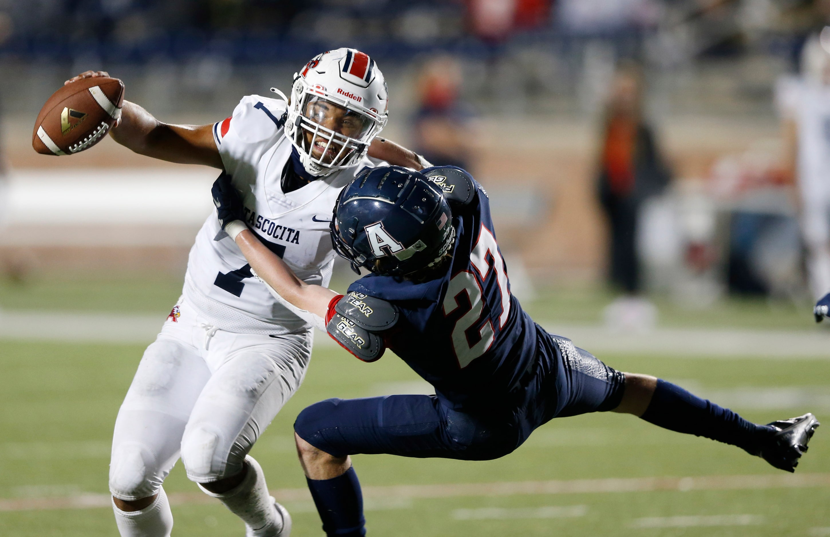 Allen's Caison Smith (27) tackles Humble Atascocita's quarterback Gavin Session (7) during...