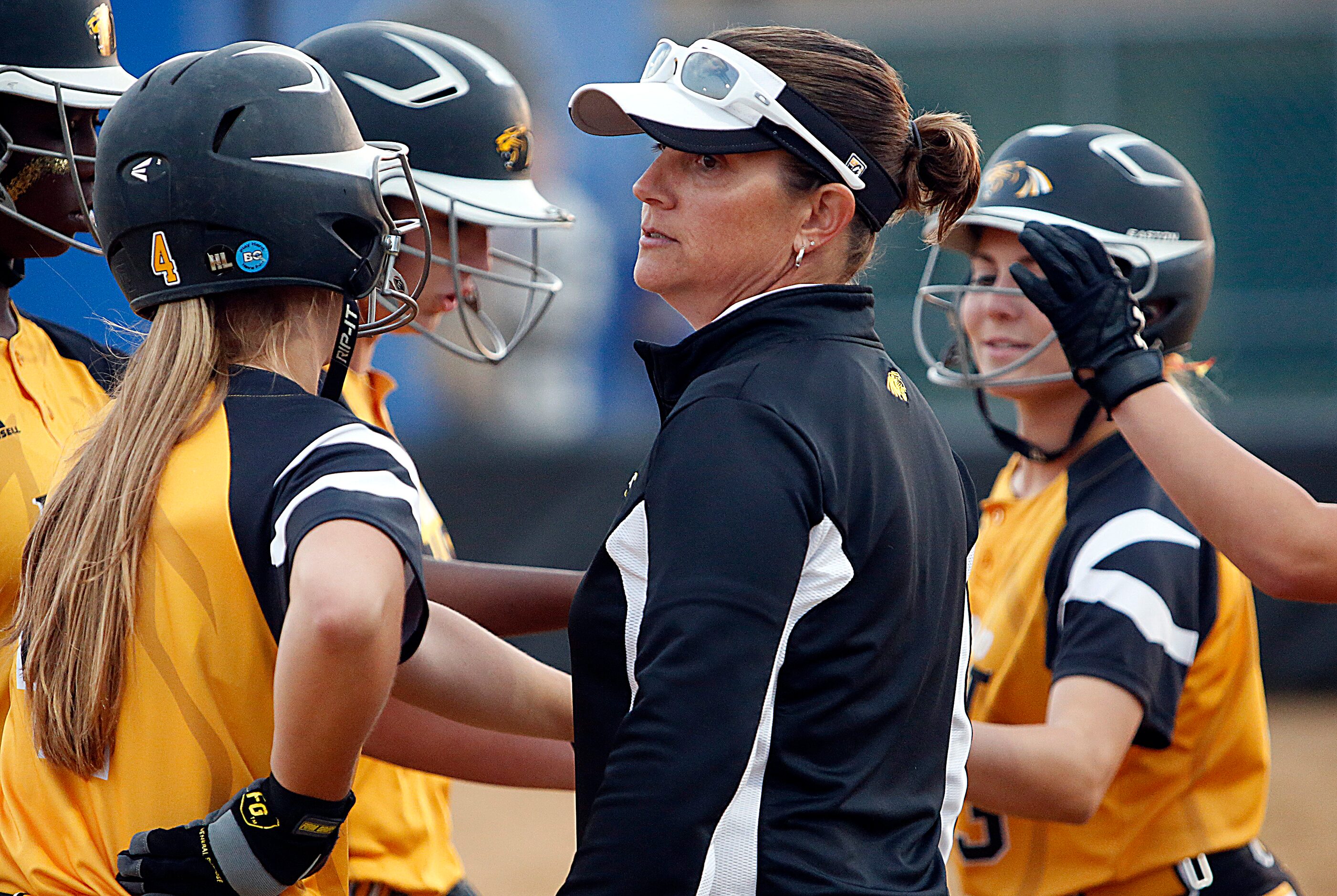 The Plano East High School varsity softball coach Karen Kalhoefer rallys her team between...