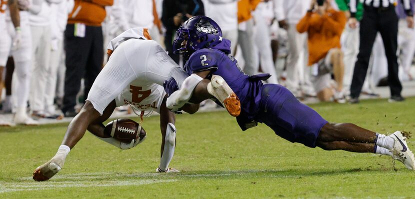 Texas Longhorns running back CJ Baxter (4) is tackled by TCU Horned Frogs cornerback Josh...