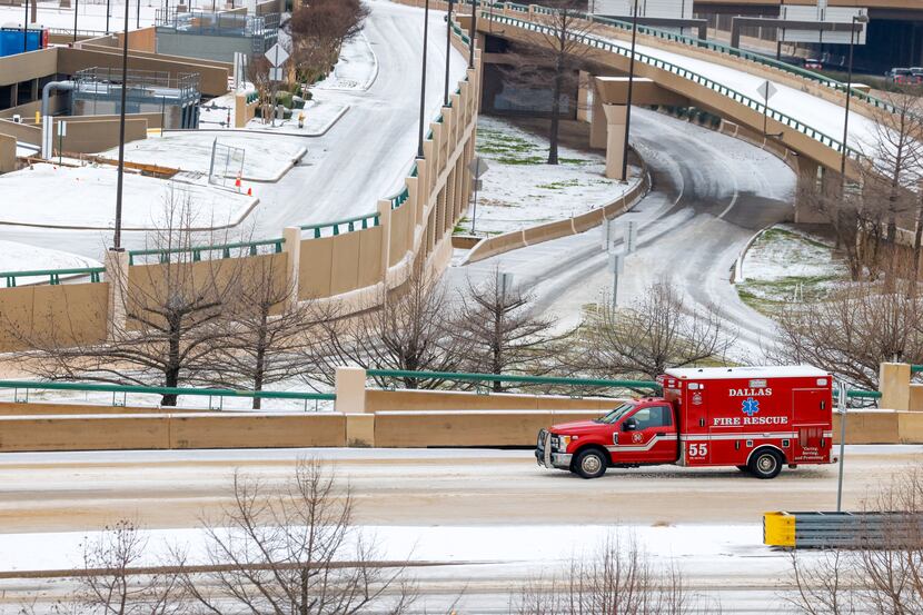 A Dallas Fire-Rescue vehicle drives over U.S. 75 via Northwest Highway in Dallas on...