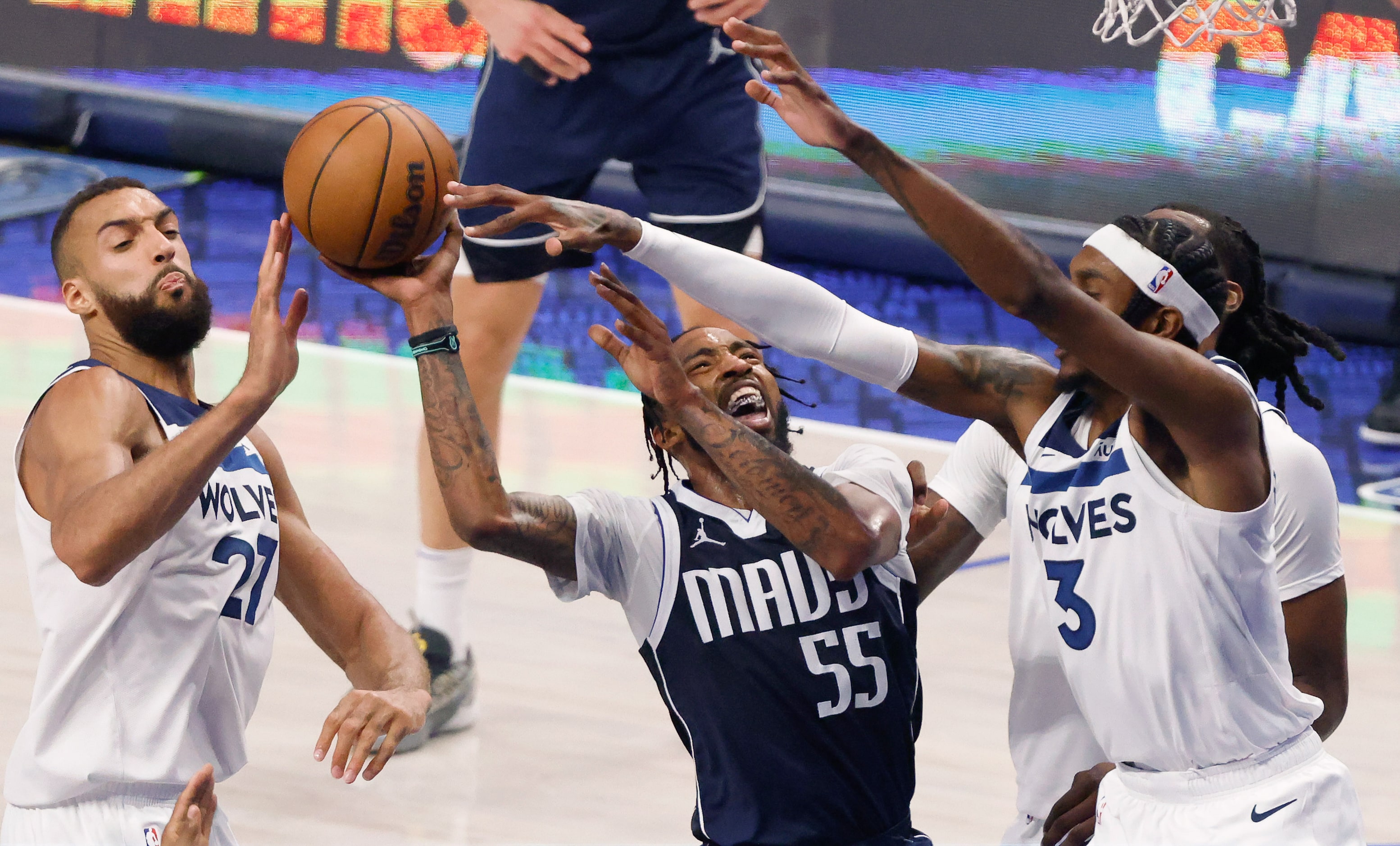 Dallas Mavericks forward Derrick Jones Jr. (55) is fouled by Minnesota Timberwolves forward...