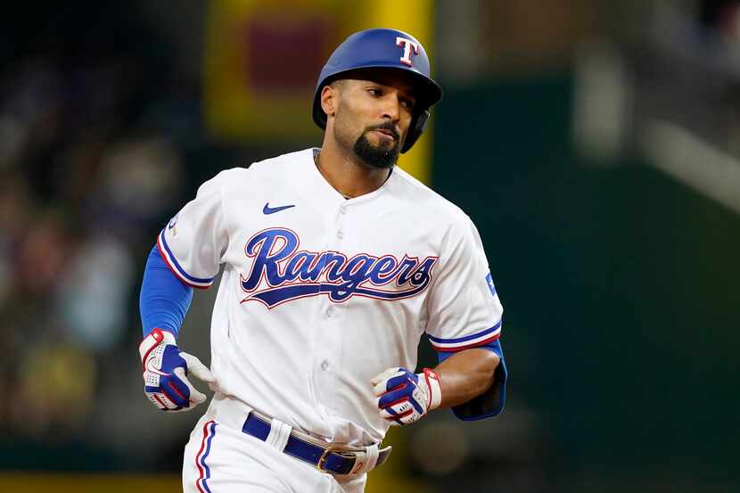 Texas Rangers' Marcus Semien rounds the bases after hitting a three-run home run in the...