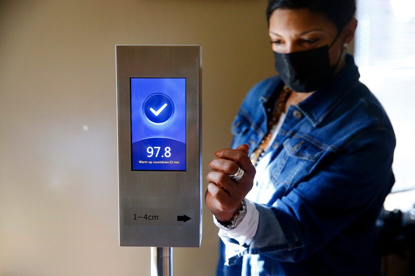 Judge Dominique Collins demonstrates how new body temperature measuring instruments will be...