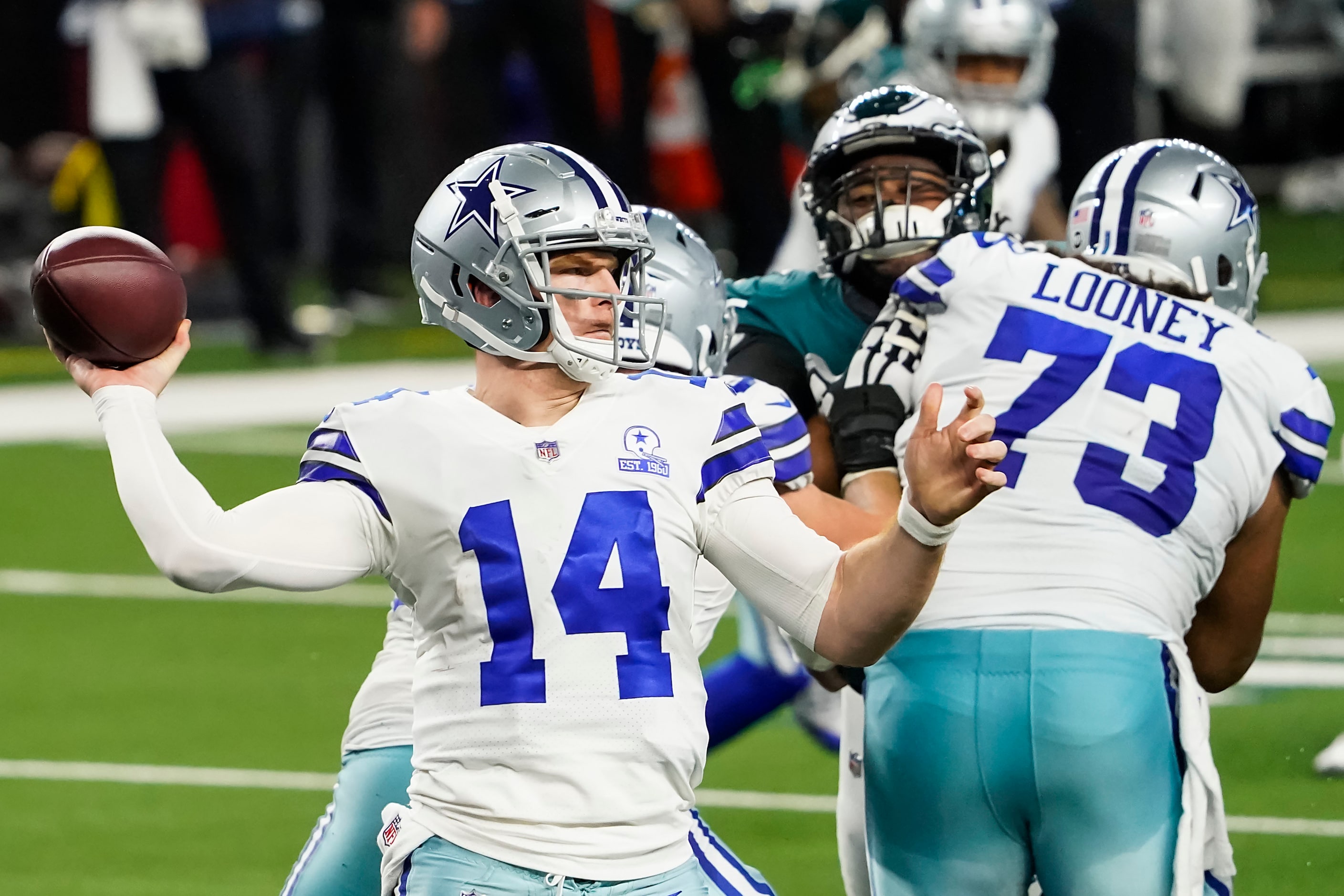 Dallas Cowboys quarterback Andy Dalton (14) gets a block from center Joe Looney (73) as he...