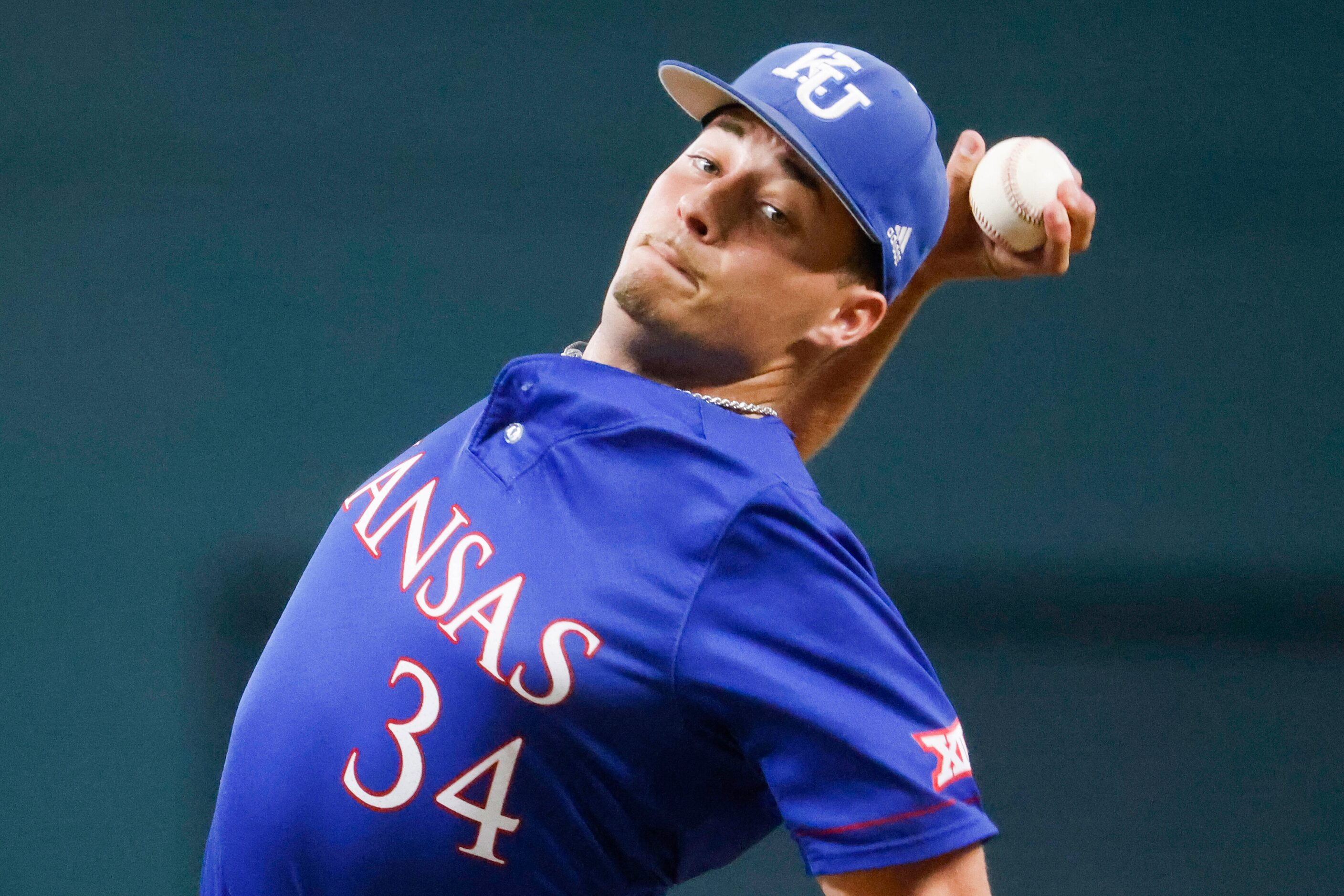 Kansas pitcher Kolby Dougan throws during the third inning of a baseball game against Kansas...