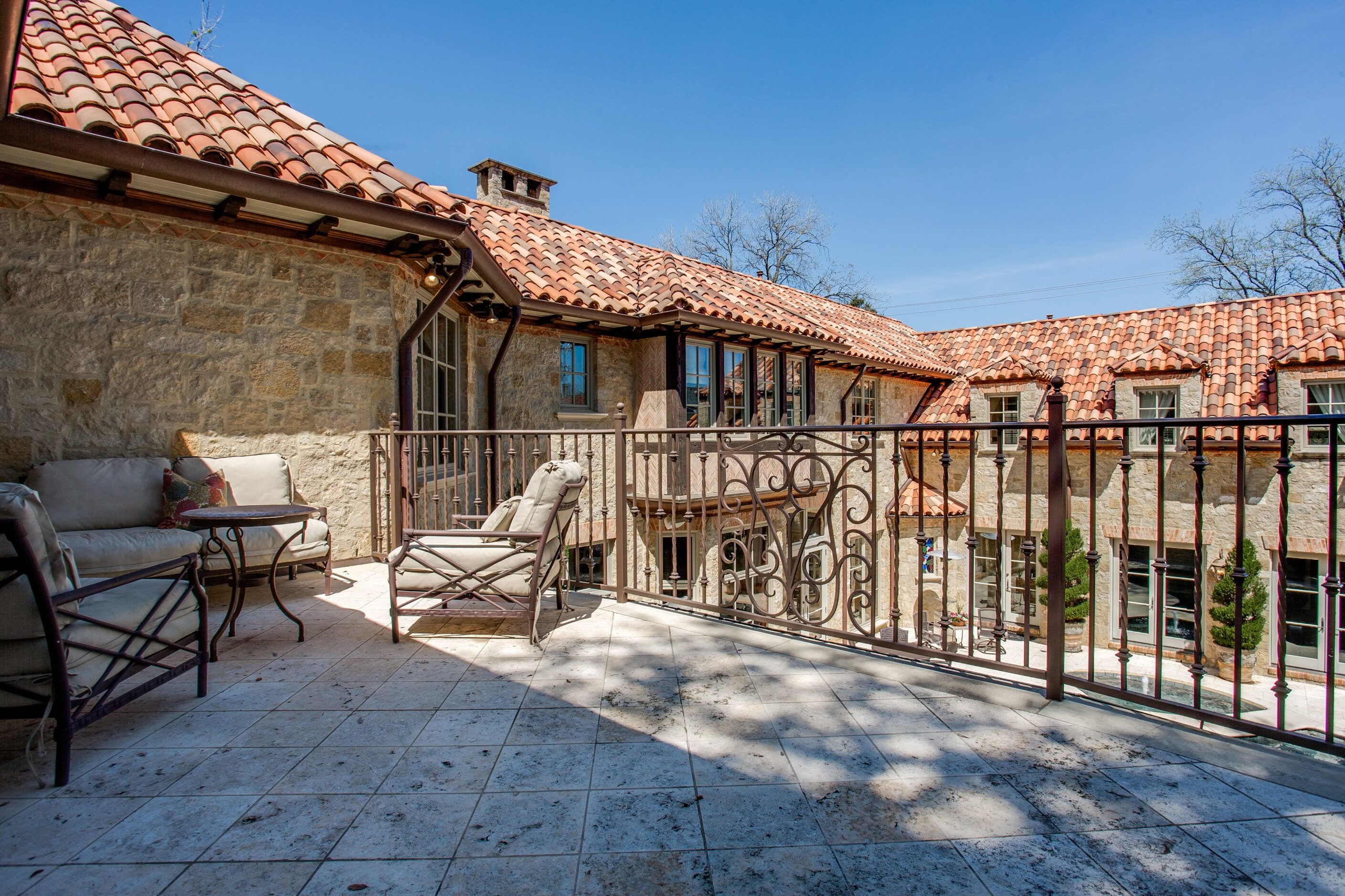 The master bedroom has a fireplace and private patio with staircase to the pool. 